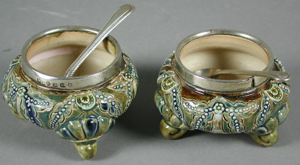 A pair of Doulton Lambeth silver mounted salts