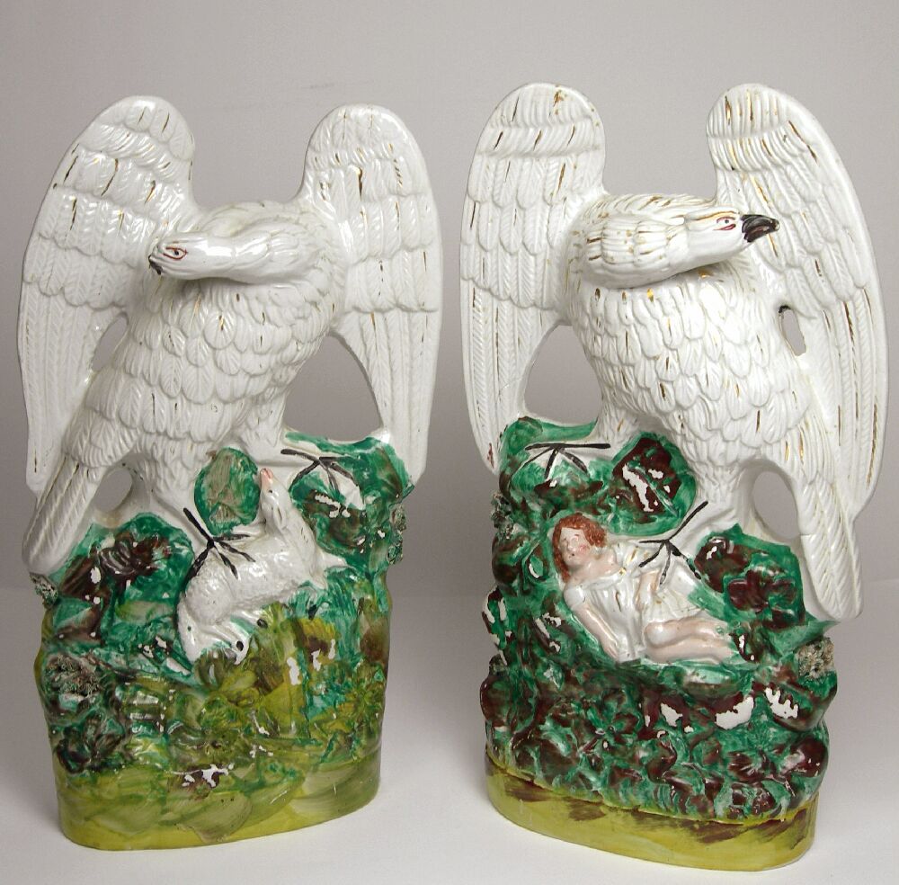A pair of 19th century Staffordshire figures of eagles