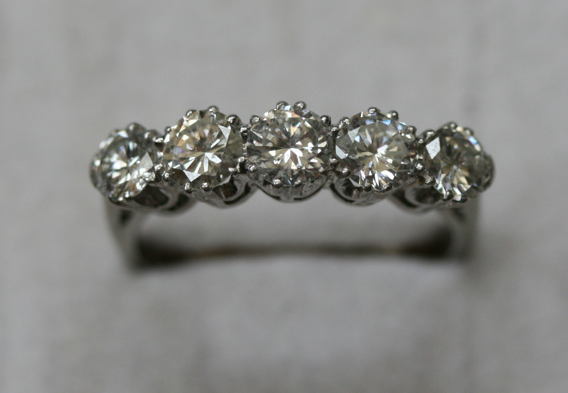 An 18ct white gold and platinum mounted five-stone diamond ring
