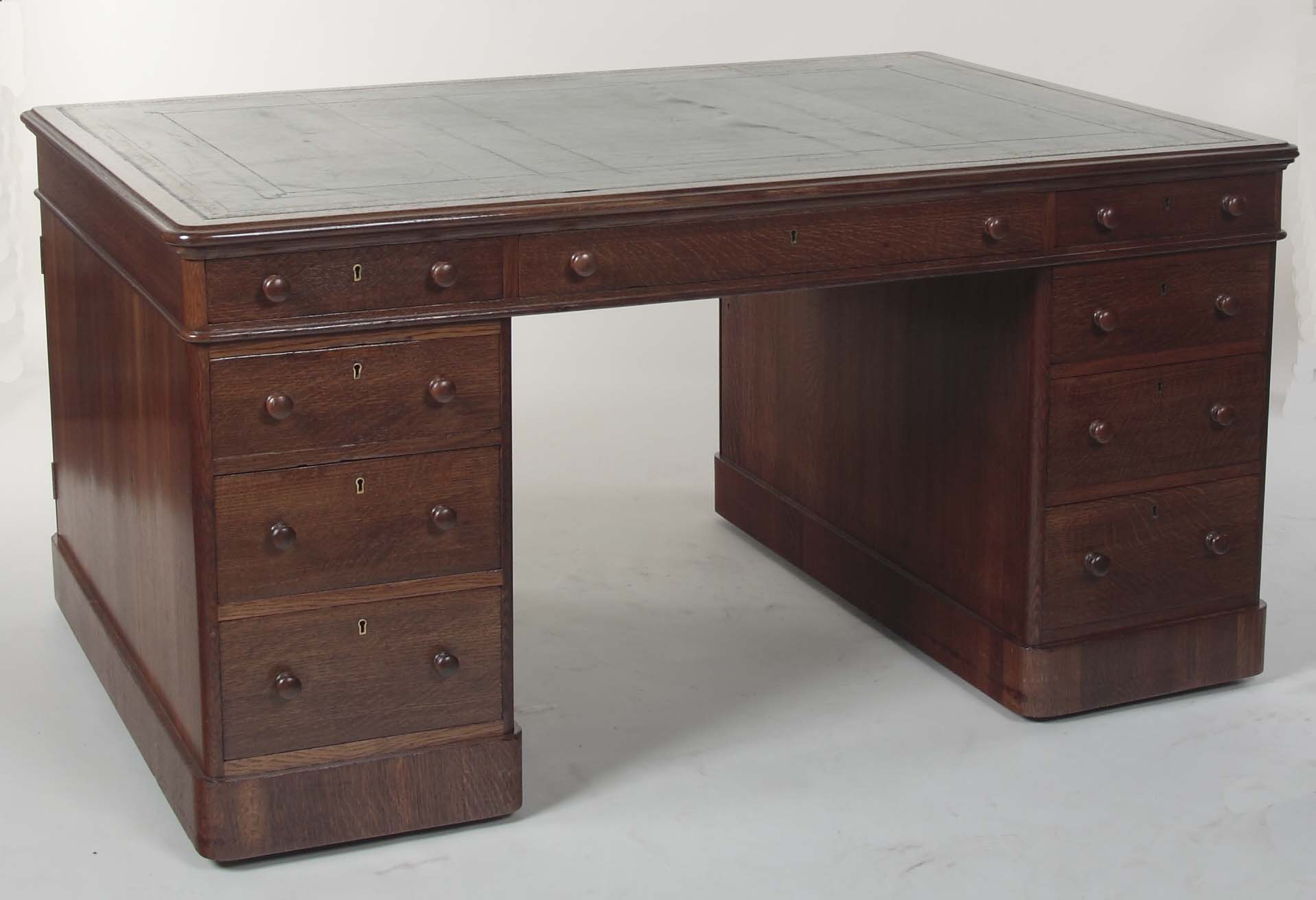 A late 19th, early 20th century limed oak partner's desk