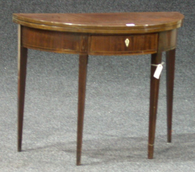 A 19th century mahogany and boxwood strung foldover tea table,