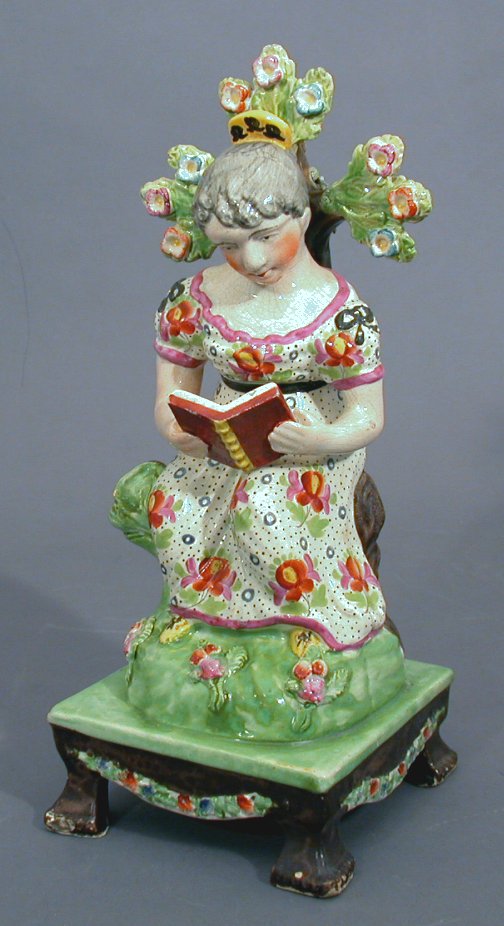A Staffordshire pearlware figure of 'The Reading Maid'