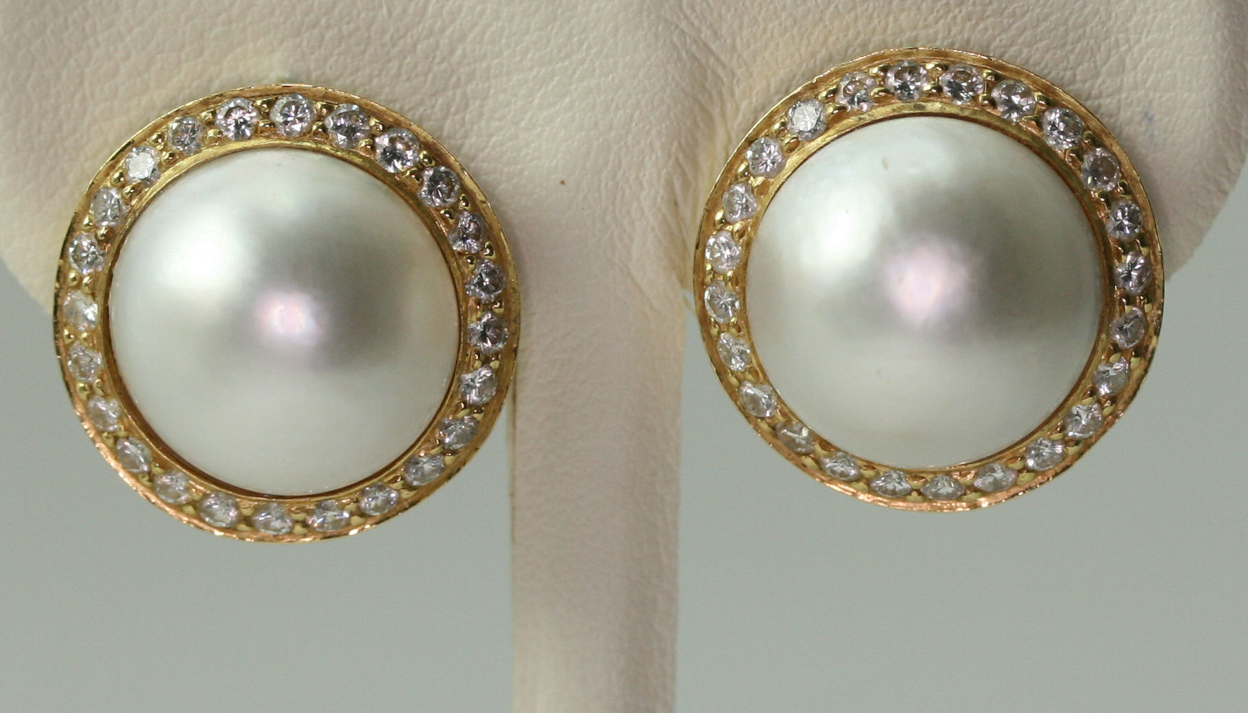 THEO FENNELL - a pair of 18ct gold mounted mabe pearl and diamond set earrings