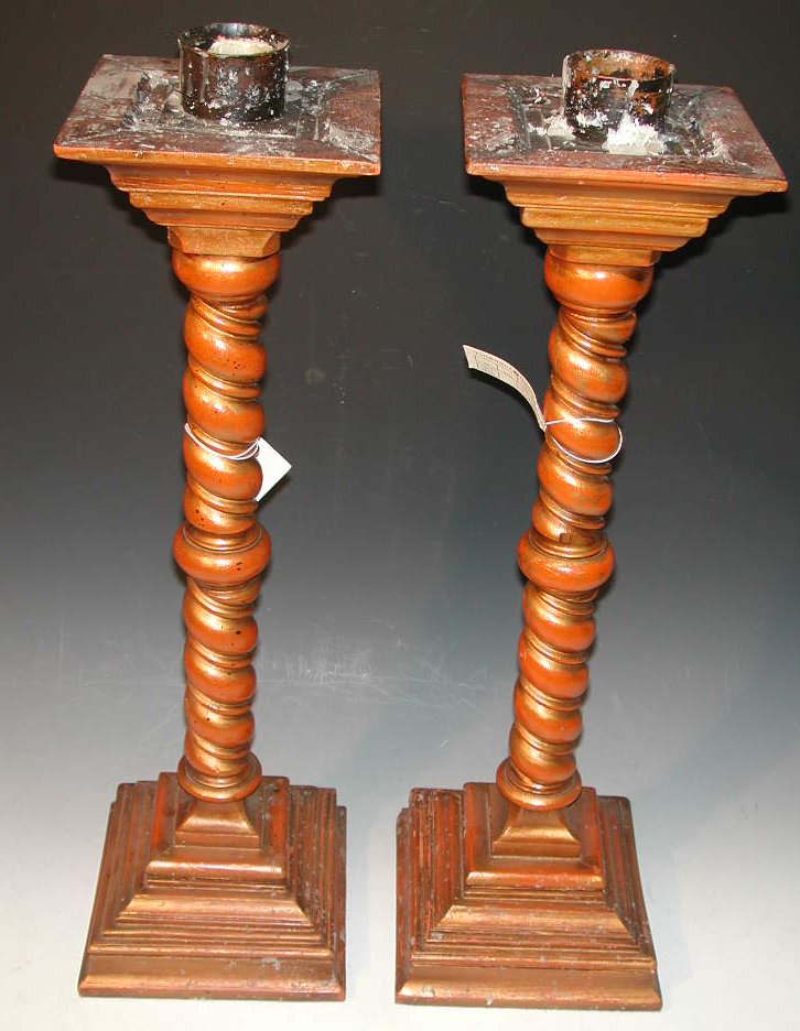 A pair of painted wooden candlesticks,
