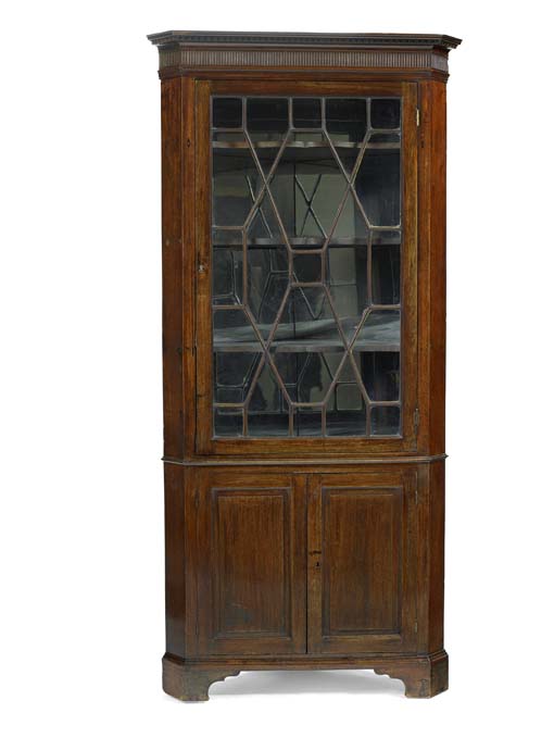 A George III mahogany standing corner cabinet