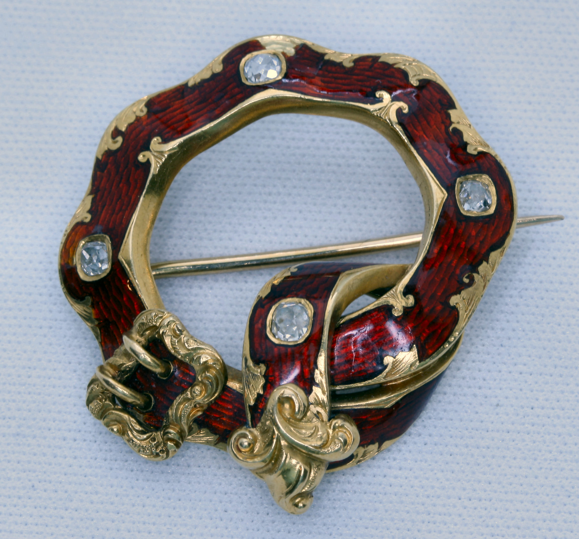 A 19th century diamond set and red enamelled brooch,
