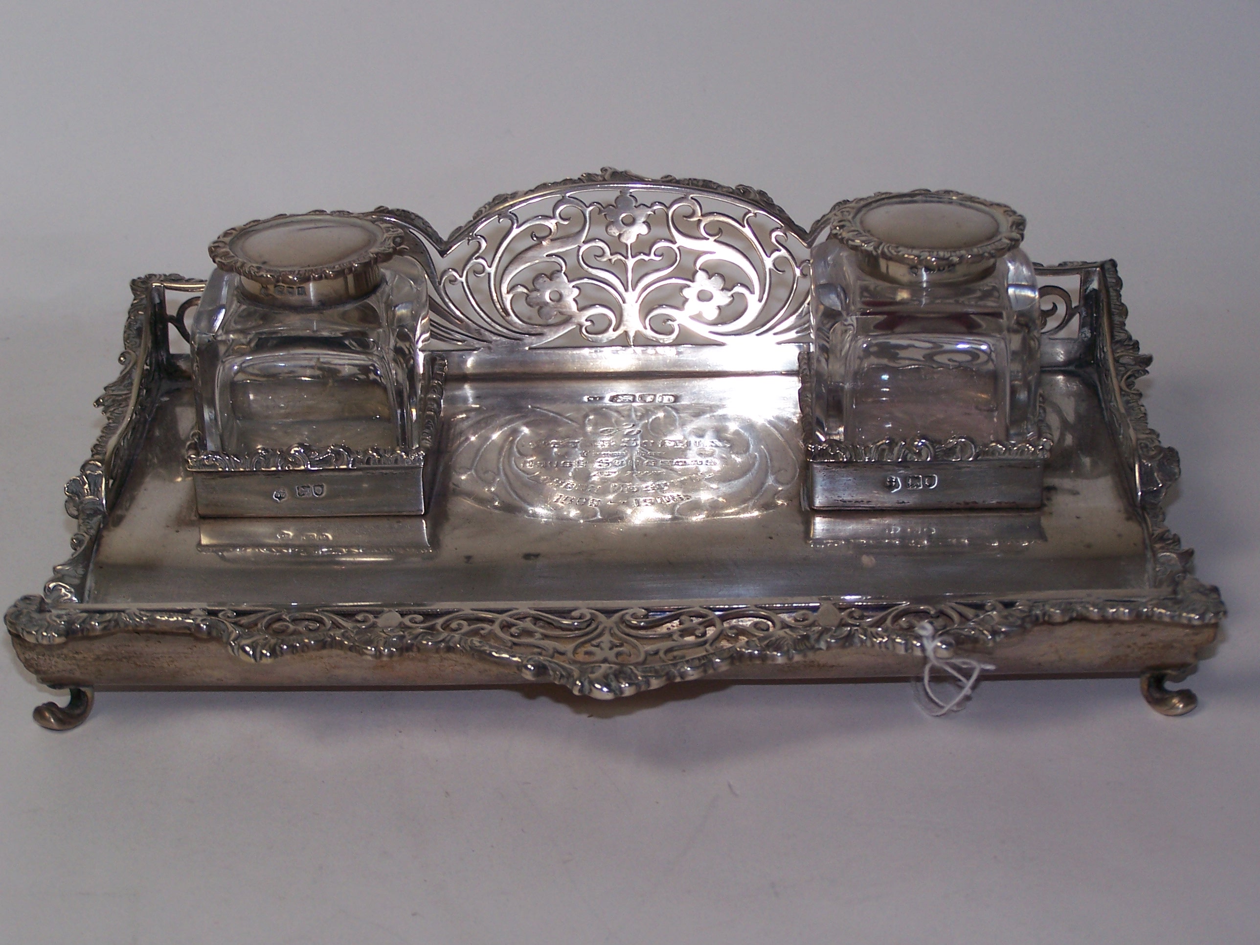 An Adam style iron and brass fire grate