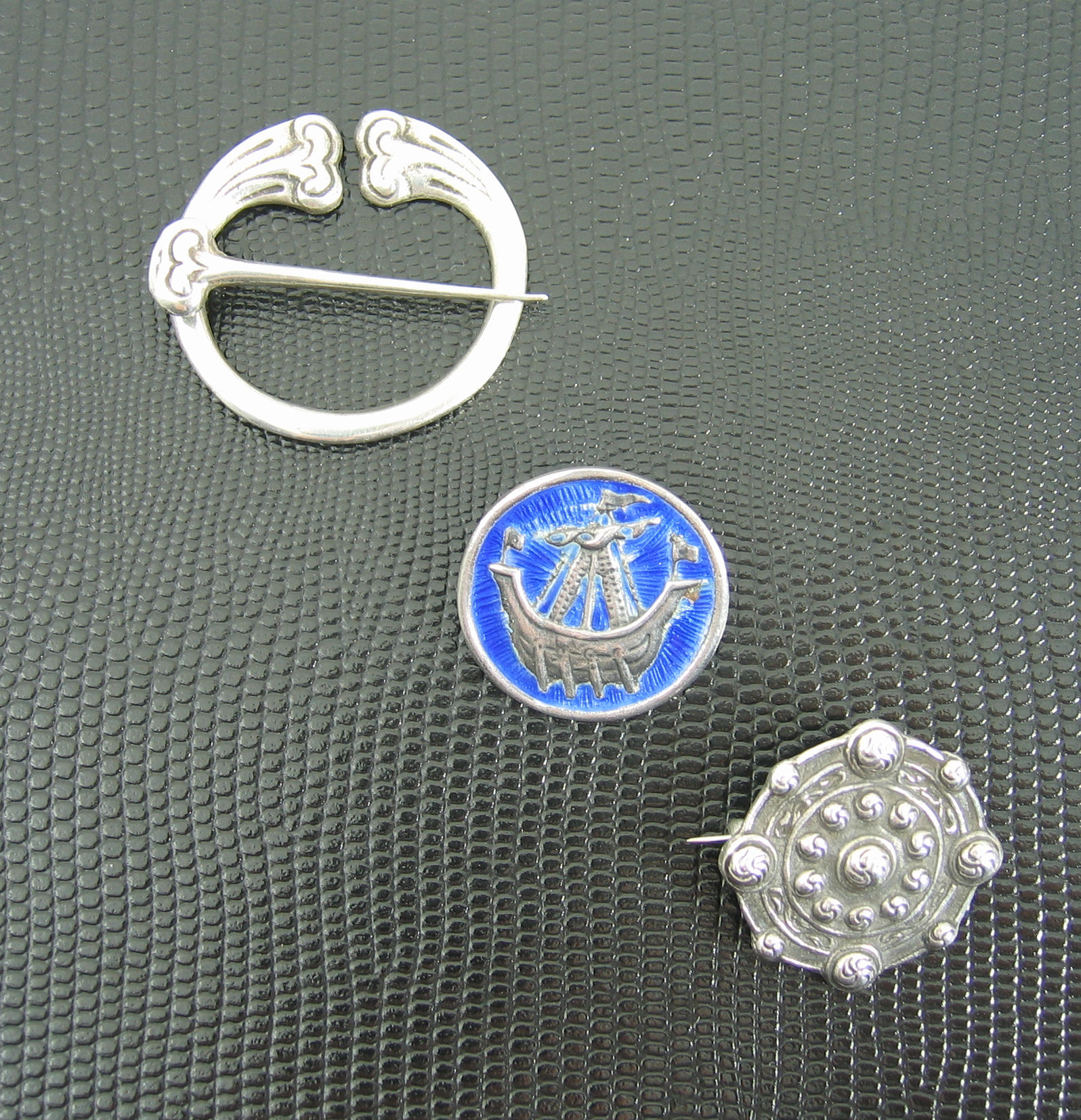 IONA - A group of three Alexander Ritchie brooches,