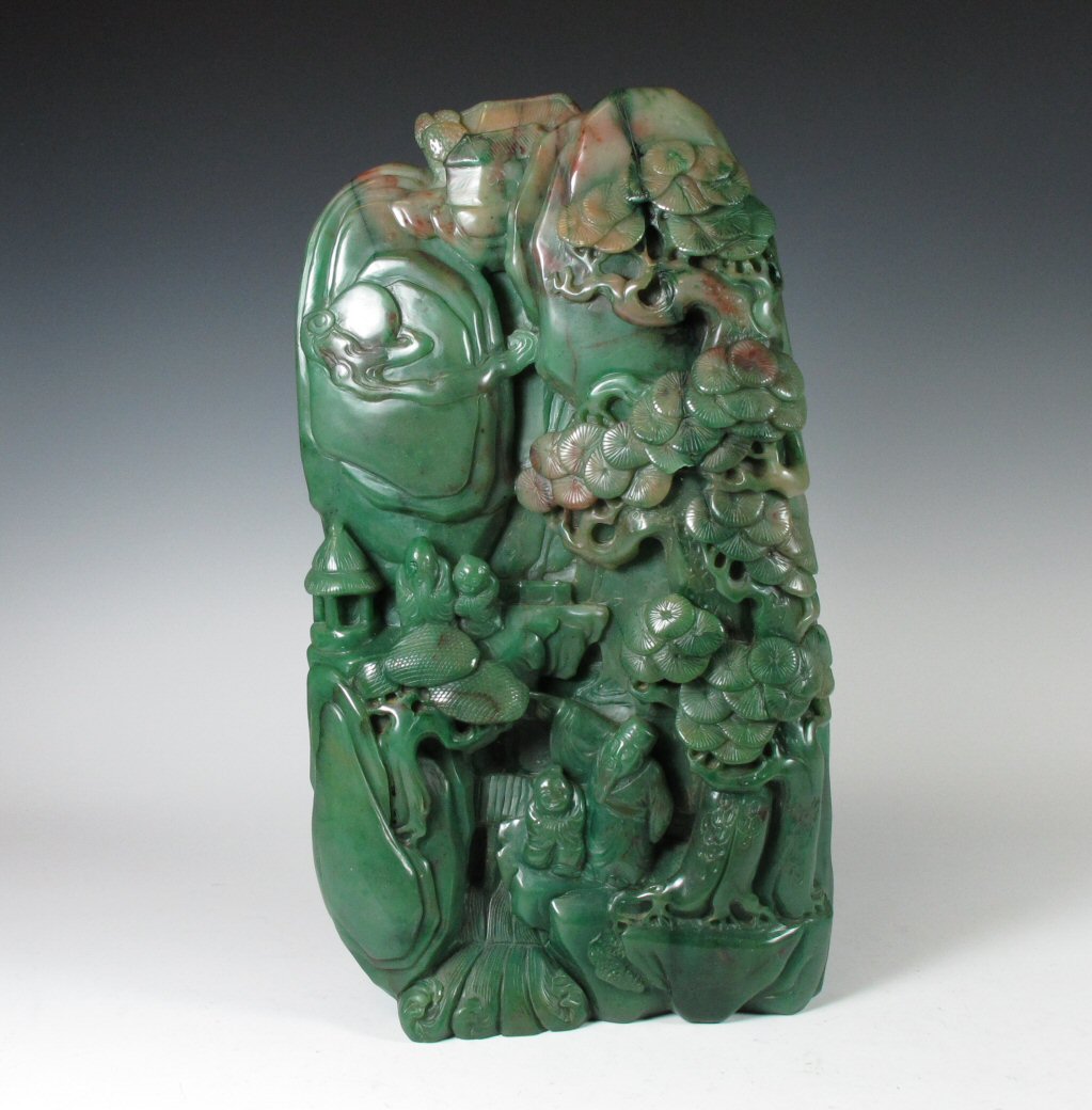 A large Chinese carved green jade boulder