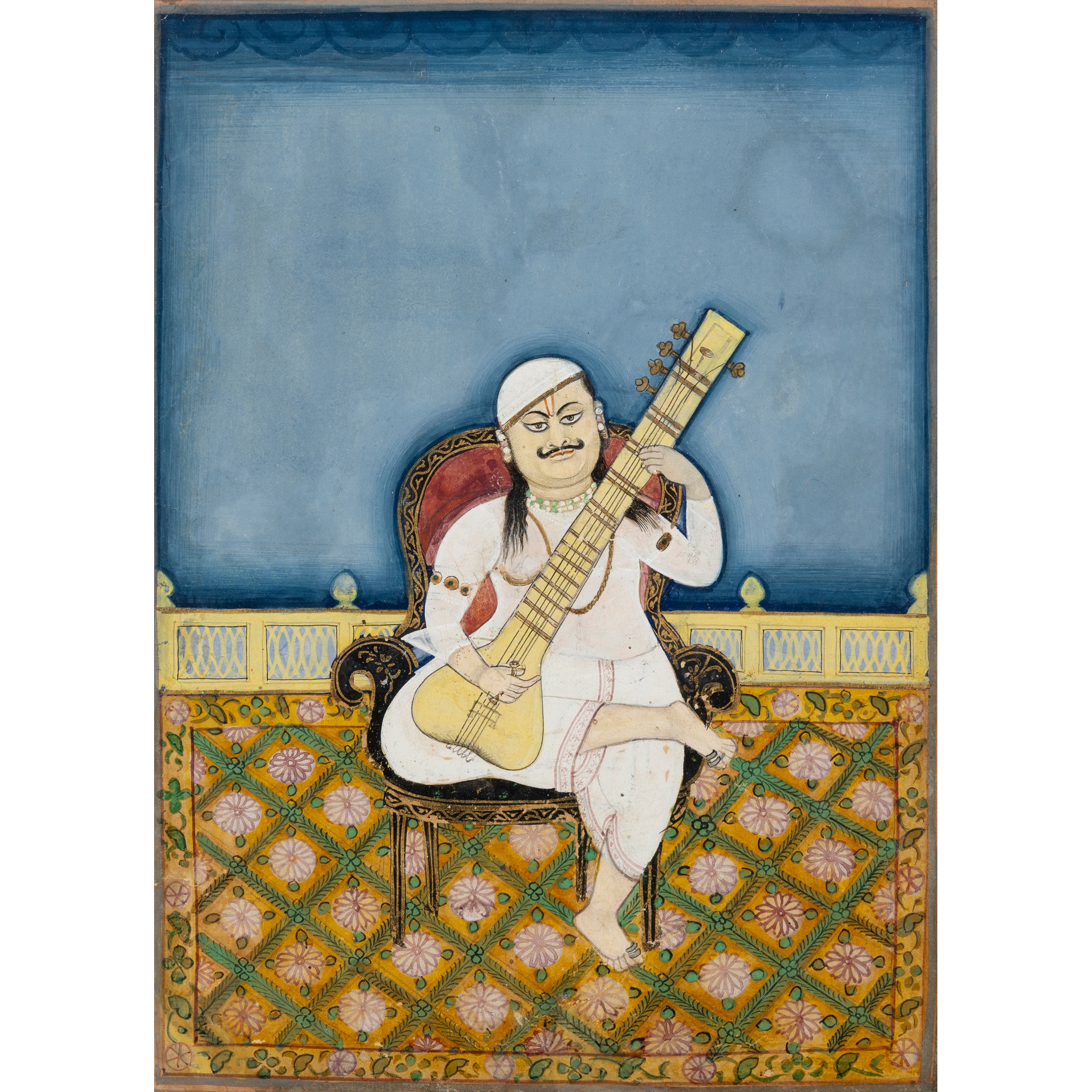 A MUSICIAN PLAYING A TAMBUR