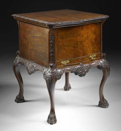 An early 20th century walnut serpentine drinks cabinet Attributed to Waring & Gillow, in the George I style