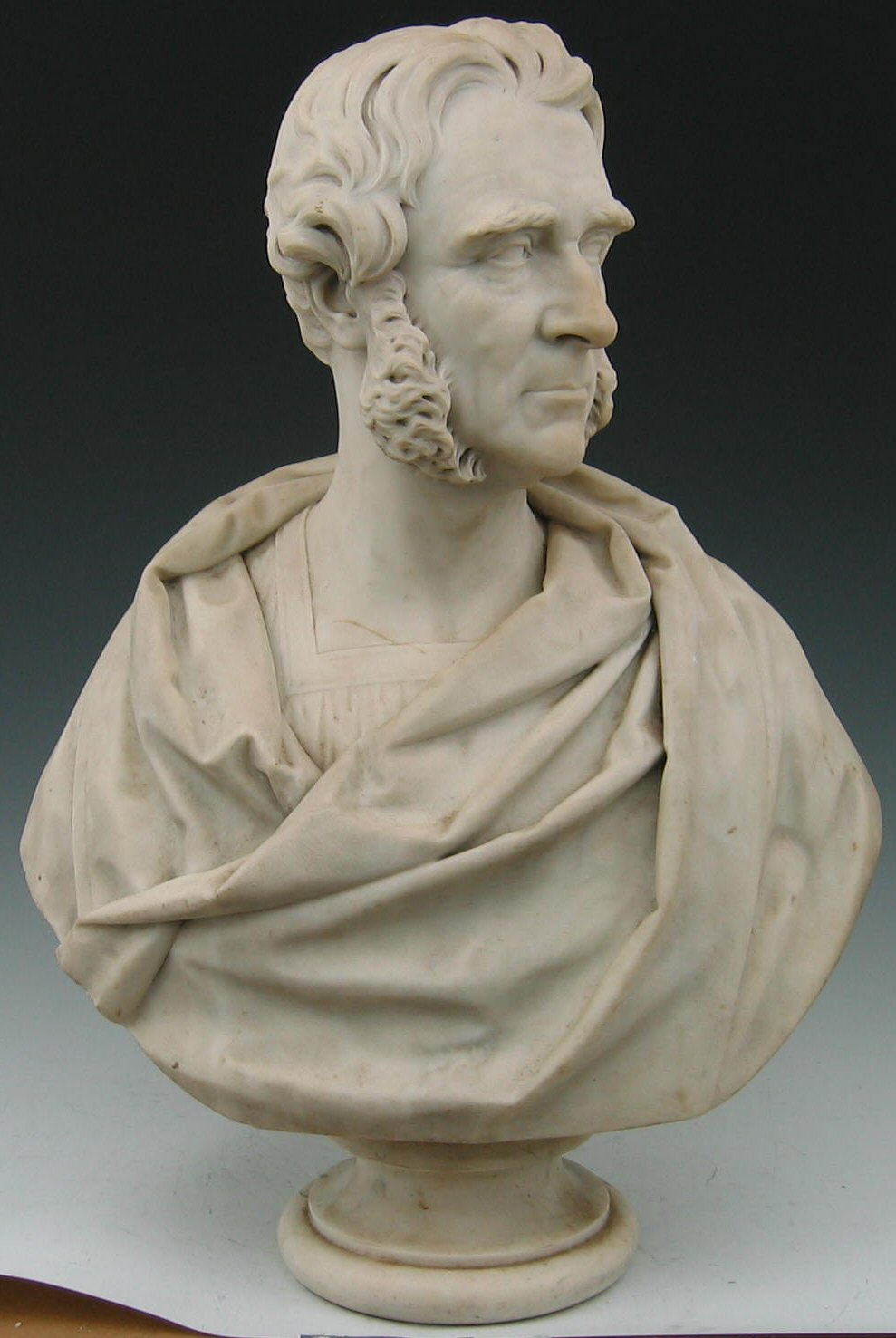 William Brodie RSA A head and shoulders marble bust of a man in classical dress,