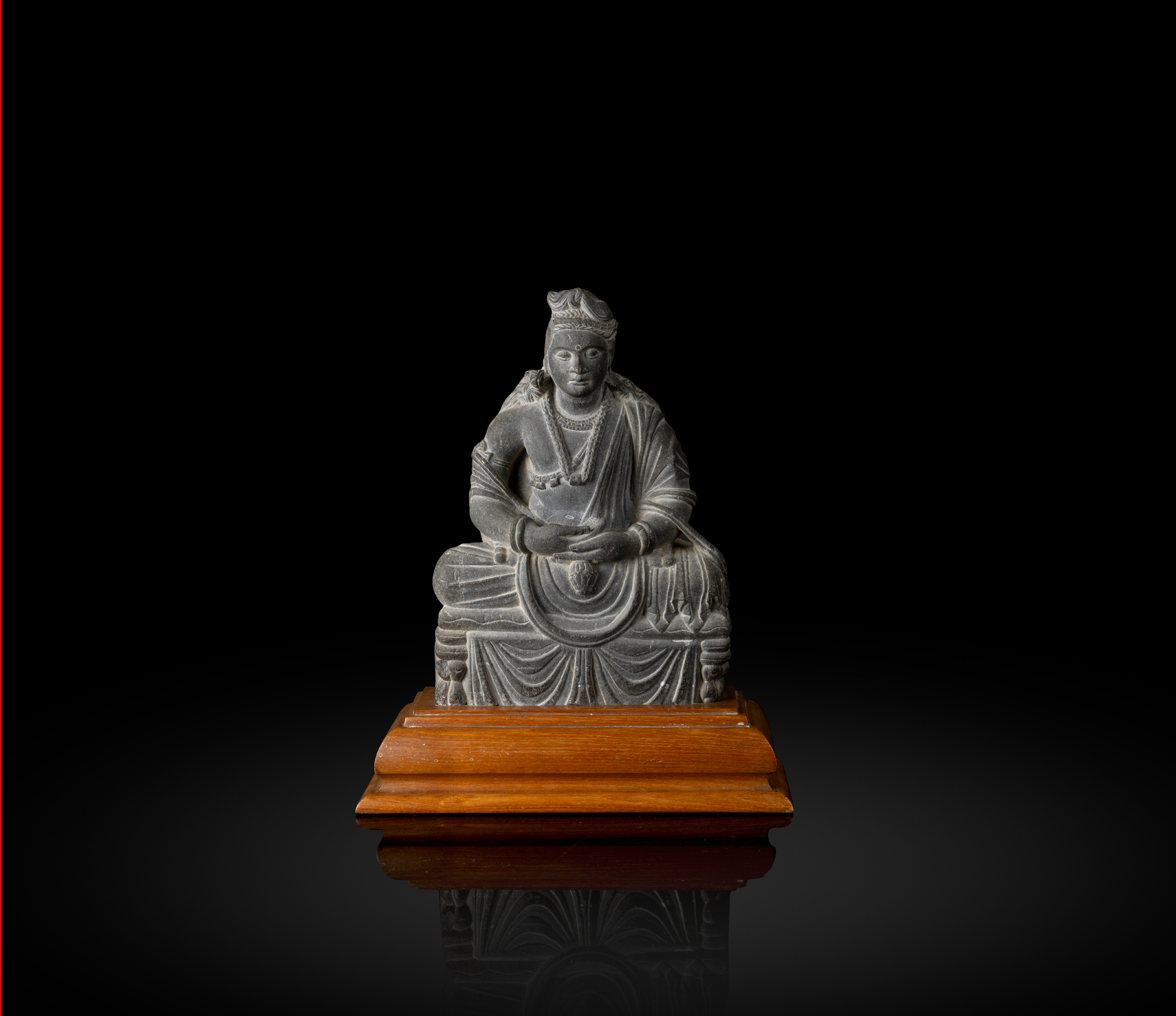 A GRAY SCHIST SEATED BUDDHA