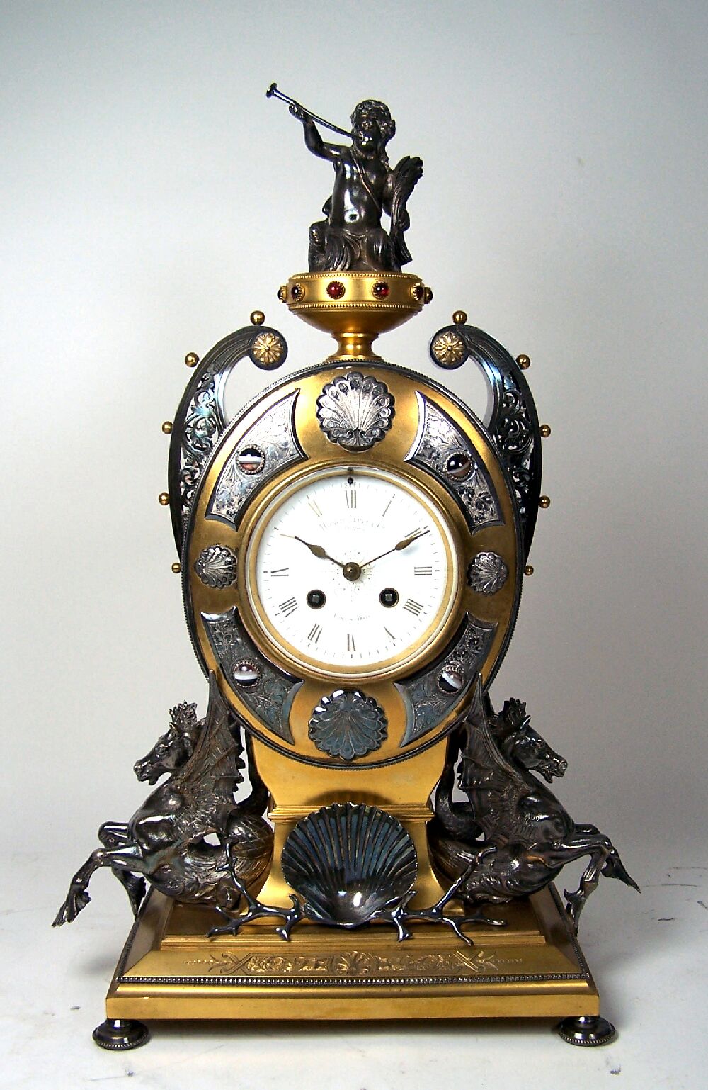 A Victorian period gilt bronze and silver plated mantel clock Designed by Edgar Finley and manufactured by Howell James & Co, London