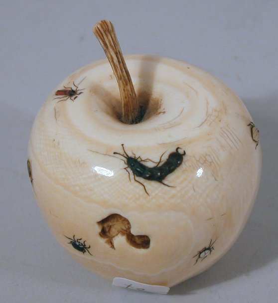 A Japanese carved ivory shibyama decorated apple