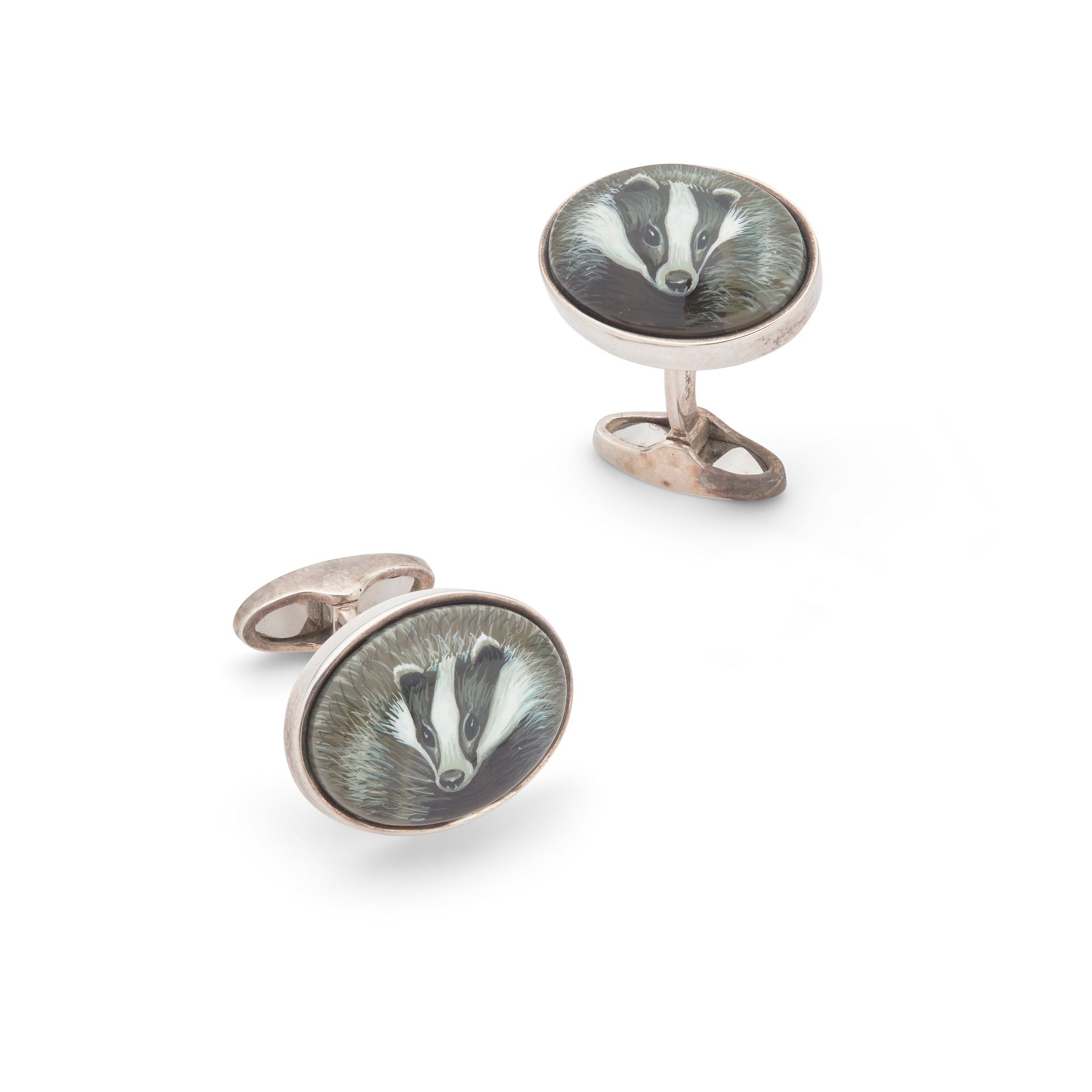 A pair of silver and enamel 'badger' cufflinks