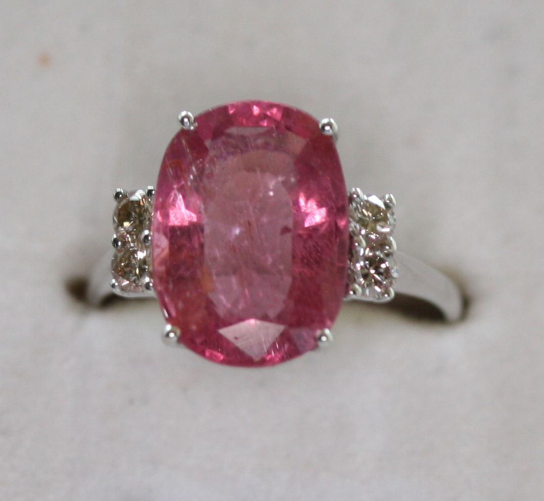 A contemporary 14ct white gold mounted pink tourmaline and diamond set ring