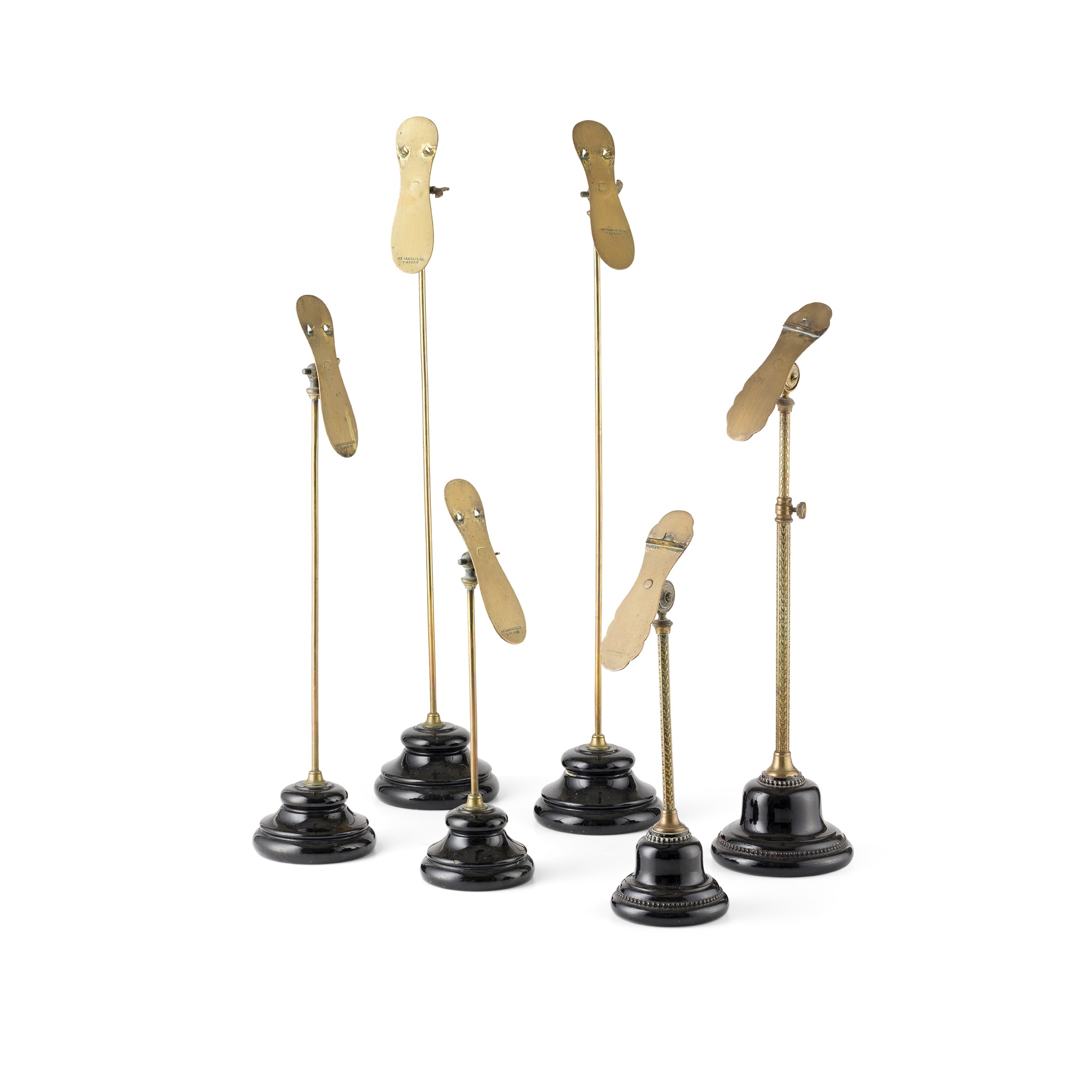 GROUP OF BRASS AND POTTERY SHOE DISPLAY STANDS