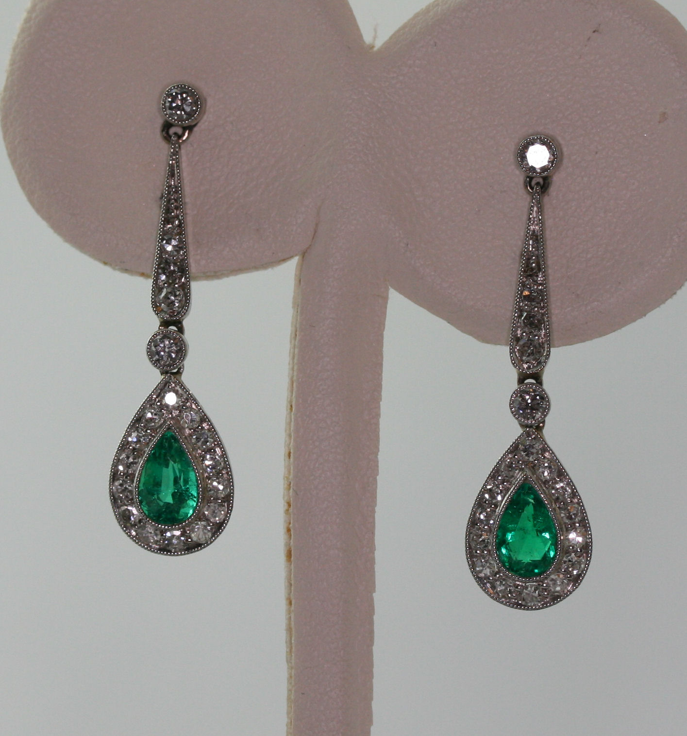 A pair of emerald and diamond set pendant earrings