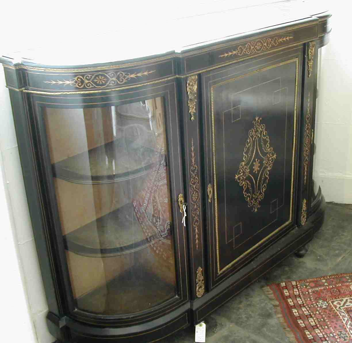A mid Victorian ebonised and giltmetal mounted credenza,