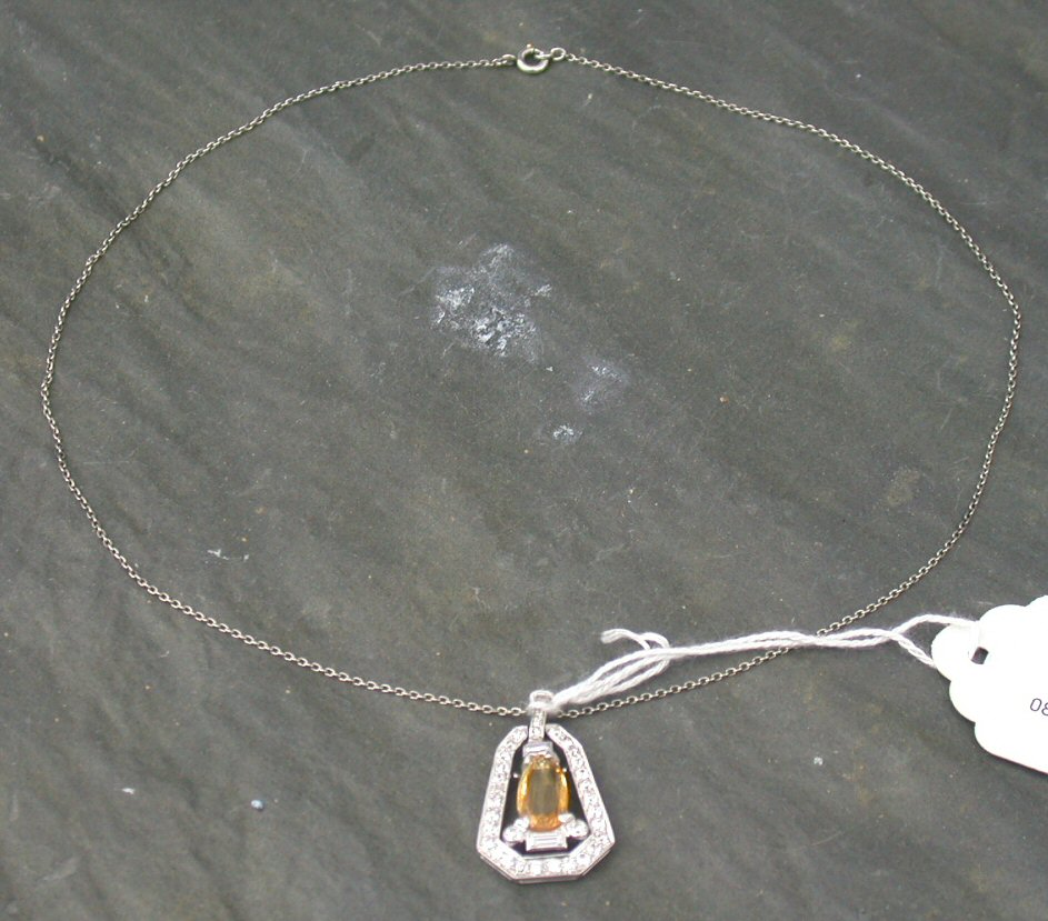 A topaz and diamond set pendant,