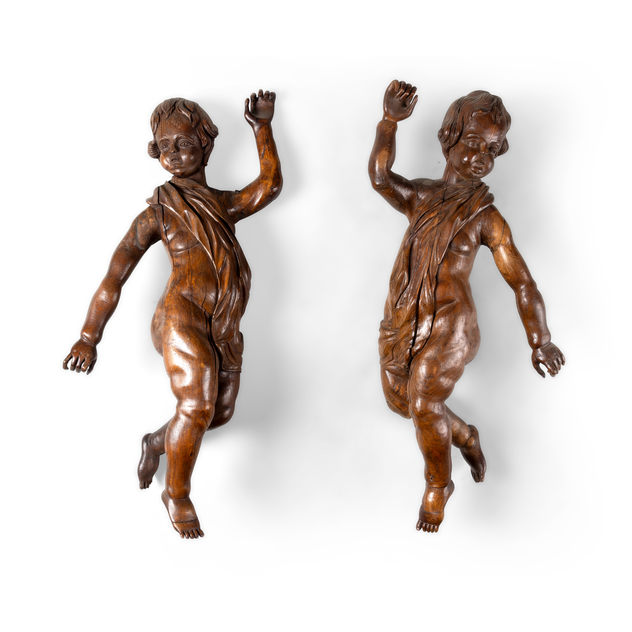 A PAIR OF CARVED OAK CHERUBS