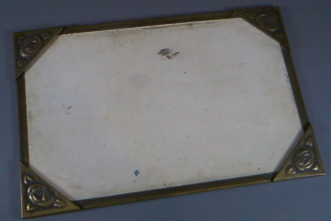 A rectangular brass blotter, designed by Margaret Gilmour,