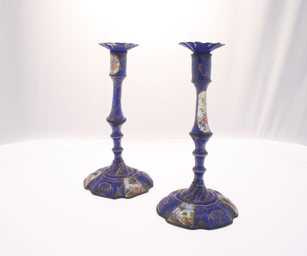 A pair of 18th century Staffordshire enamel candlesticks