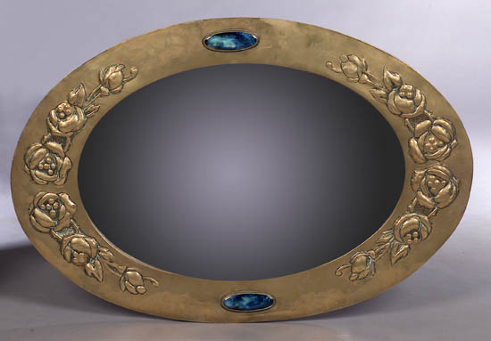 A Scottish School Arts and Crafts brass wall mirror