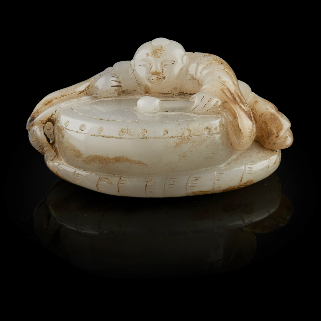 GREY JADE CARVING OF A BOY PLAYING A DRUM