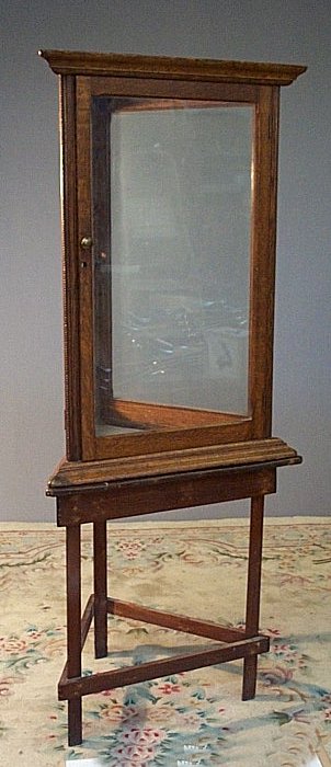 An unusual oak display cabinet of triangular form