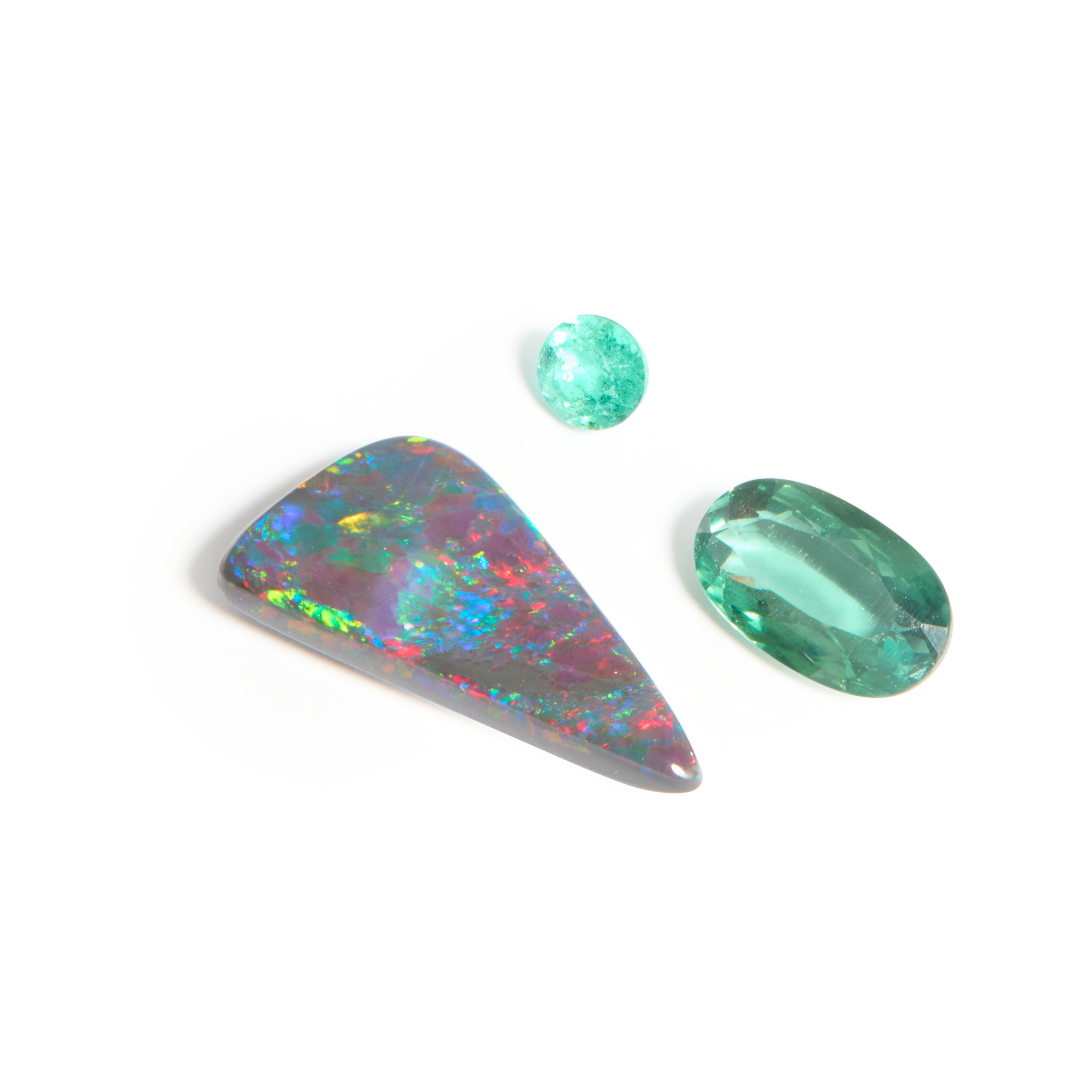 A collection of three unmounted gemstones