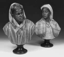 A pair of painted terracotta busts of female Moors
