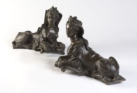 A pair of 18th century bronze female mask sphinxes