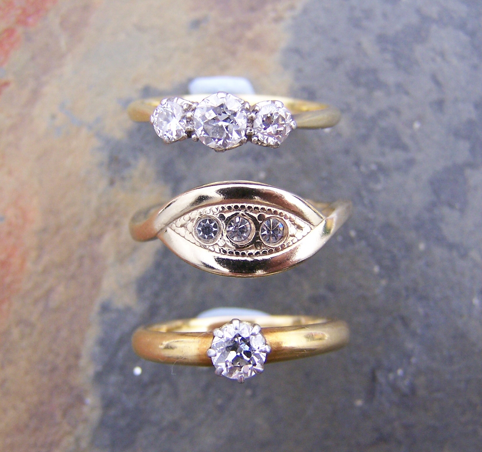 An 18ct gold mounted three-stone diamond ring,