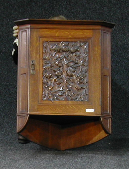 An oak hanging corner cabinet,