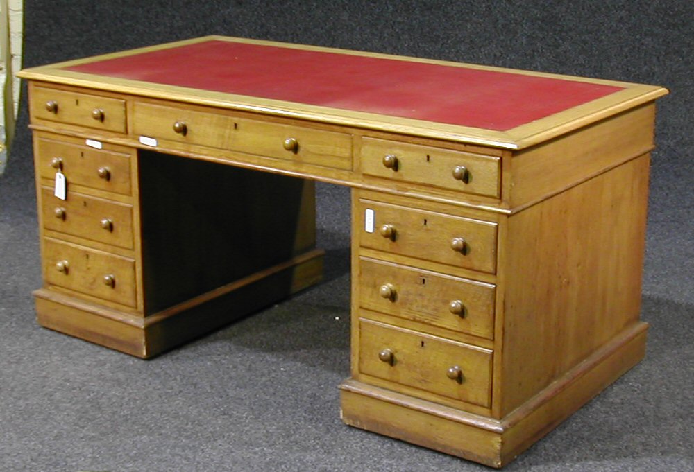 An early 20th century oak twin pedestal writing desk,