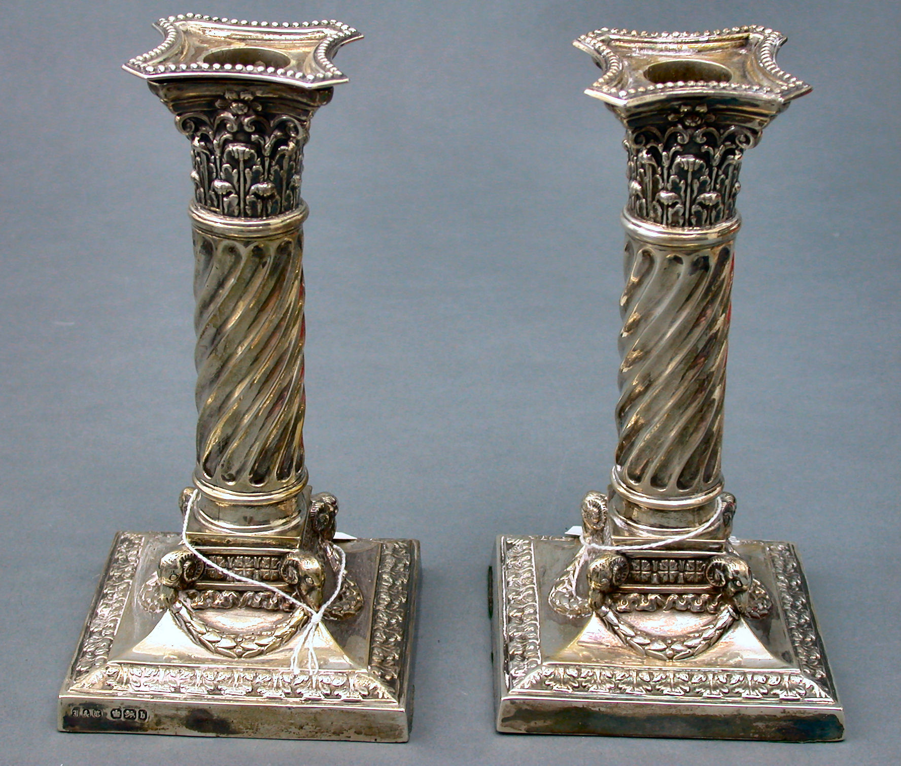 A pair of late Victorian candlesticks,