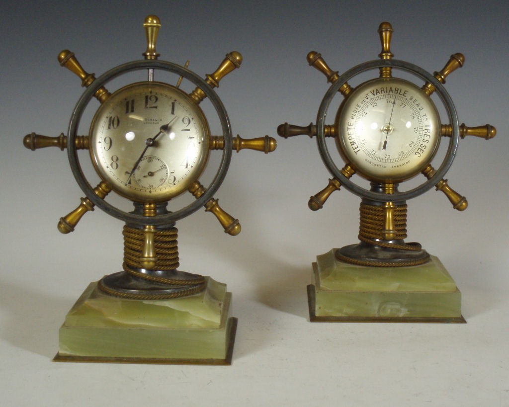A pair of early 20th century clock and barometer desk stands