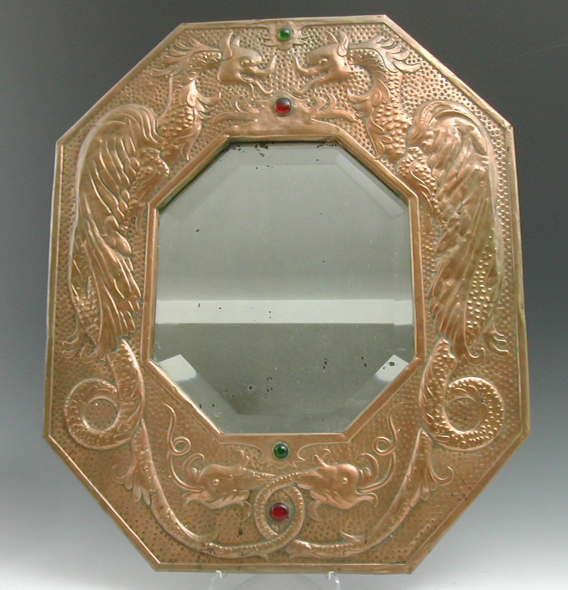 An Arts and Crafts copper framed wall mirror,