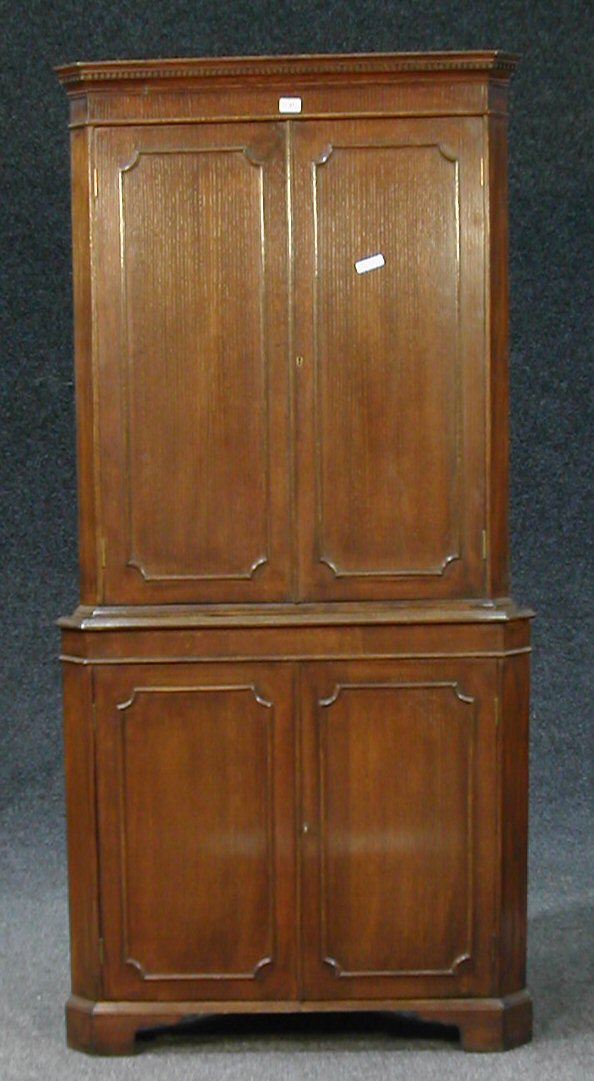 An oak graduated corner cabinet,