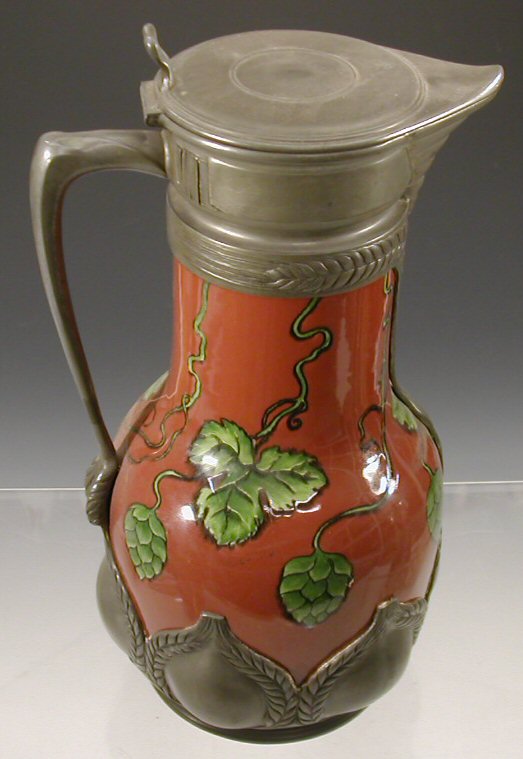 An Orivit pewter mounted earthenware wine flagon