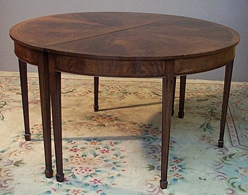 A pair of George III style mahogany demi-lune tables