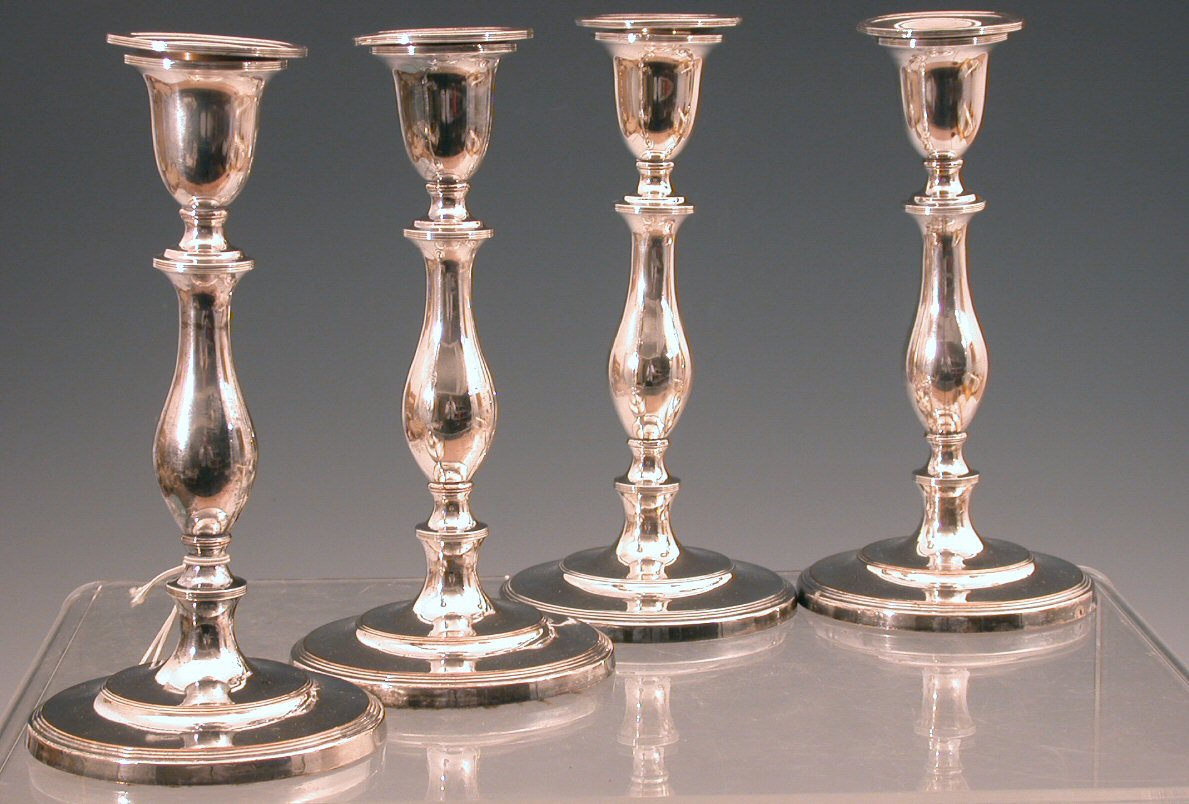 A set of four early 19th century Sheffield plated table candlesticks