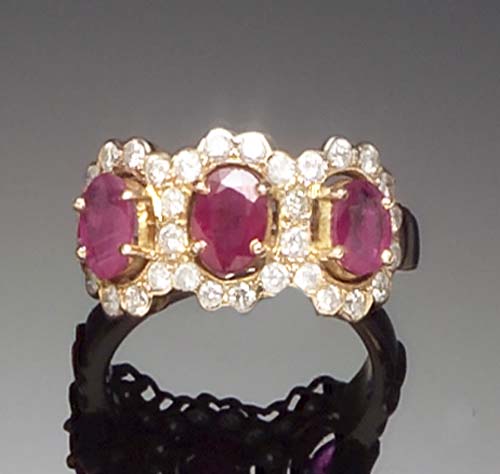 A continental yellow gold mounted ruby and diamond triple cluster ring,