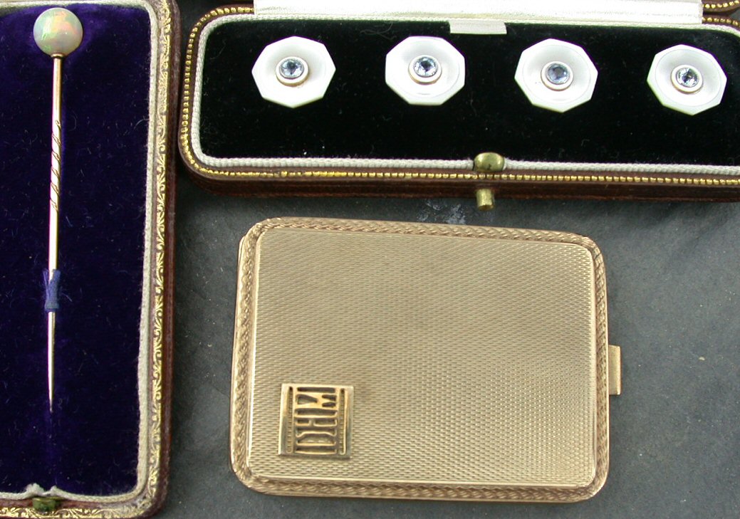 A cased set of four gold mounted mother of pearl studs,