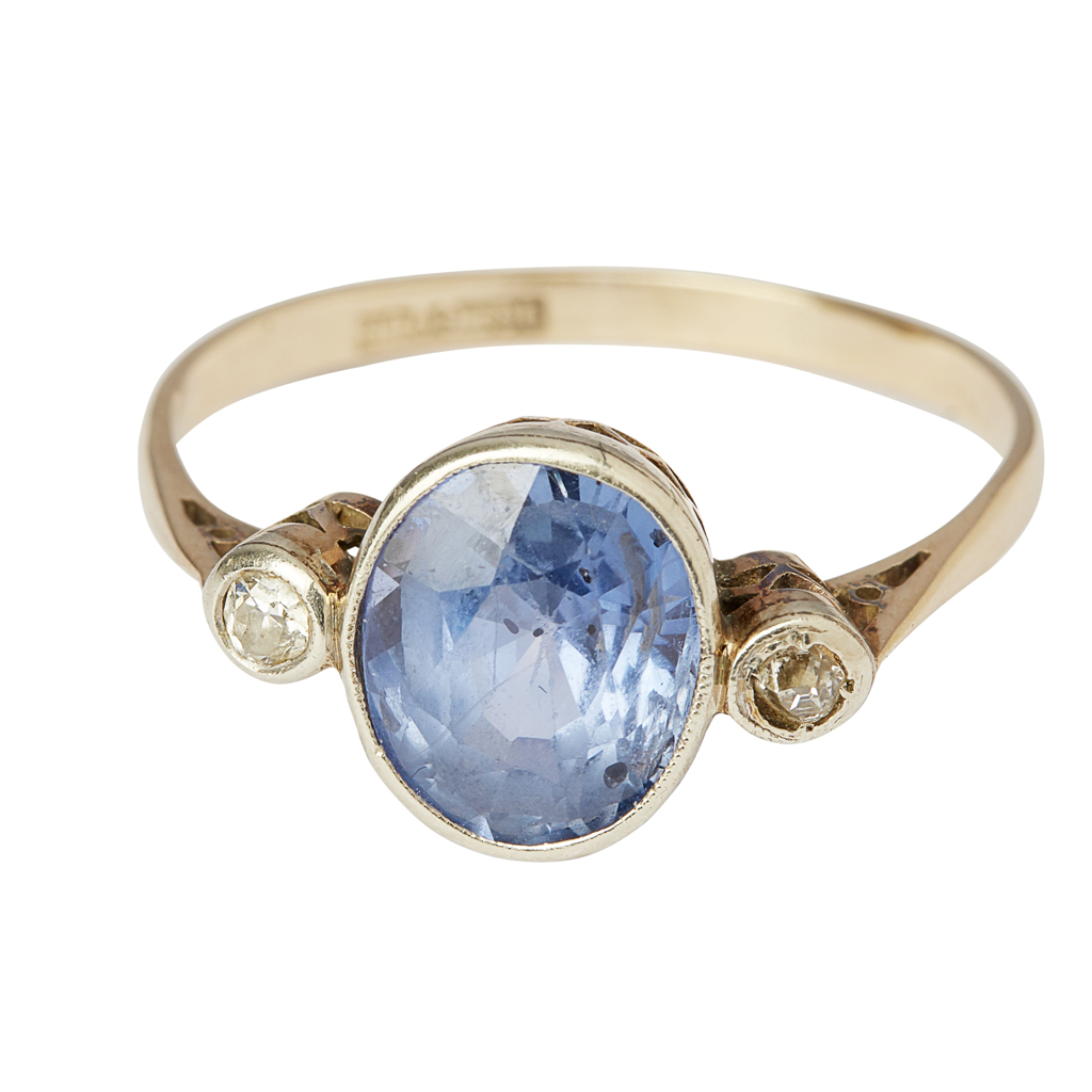 A sapphire and diamond set three stone ring