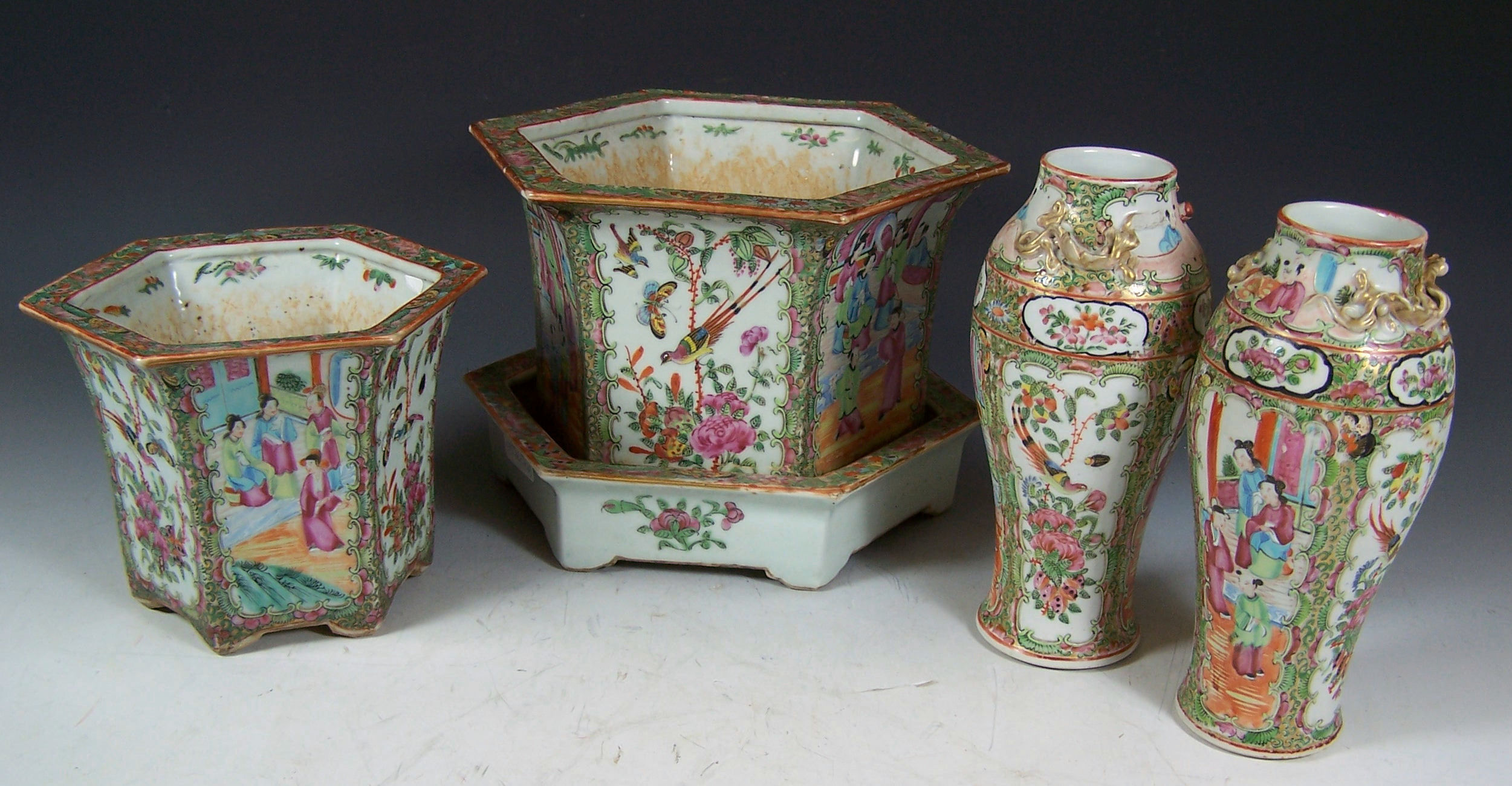 A late 19th century famille rose hexagonal form jardiniere and matching stand,