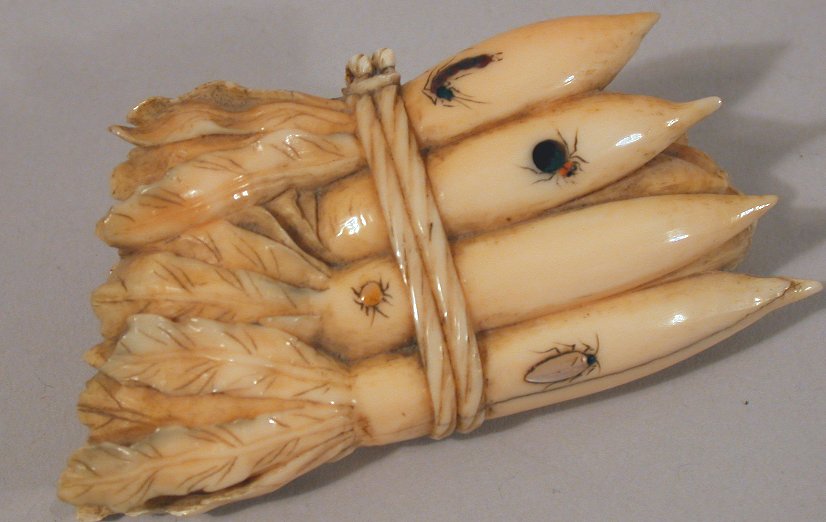 A Japanese carved ivory shibyama decorated tied bunch of carrots