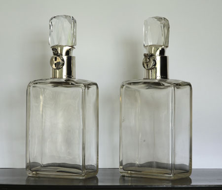 A pair of silver mounted glass decanters and stoppers